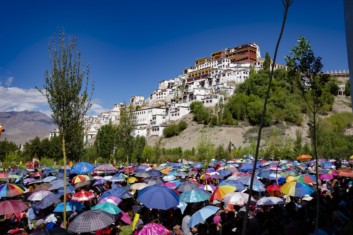 Une vue du monastère de Thiksey sur la colline; beaucoup des 2 500 personnes qui assistent à la cérémonie d'inauguration des travaux de la bibliothèque et du centre d'apprentissage utilisent des parapluies pour se protéger du soleil à Leh, Ladakh, Inde, le 29 juillet 2018. Photo de Tenzin Choejor